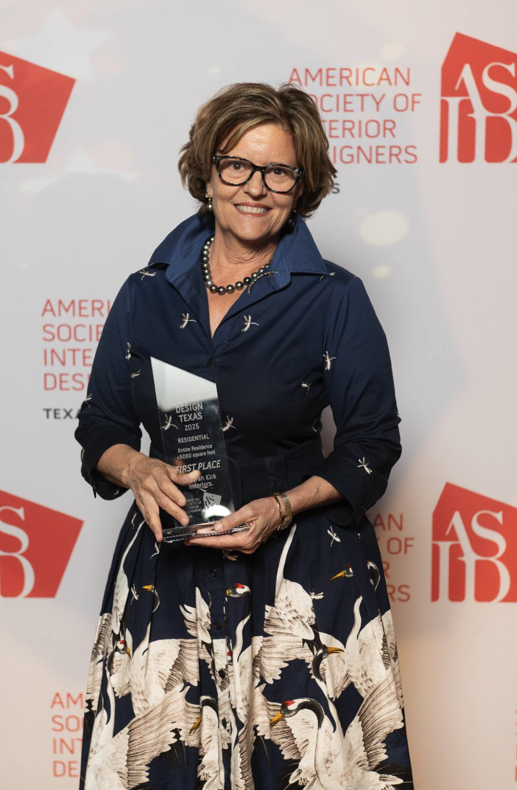 Deborah Kirk holding the Celebrating Design Texas 2025 First Place trophy